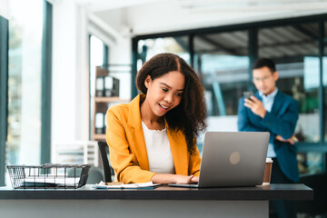Asian business man and African American woman engaging in business discussion, possibly about merger or joint venture. two companies become one, one of companies often survives while other disappears