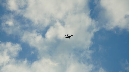 One old plane flying over with the blue sky as background