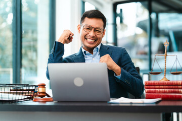 Attractive Asian male lawyer businesspeople in blue suit working at desk.