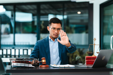 Attractive Asian male lawyer businesspeople in blue suit working at desk.