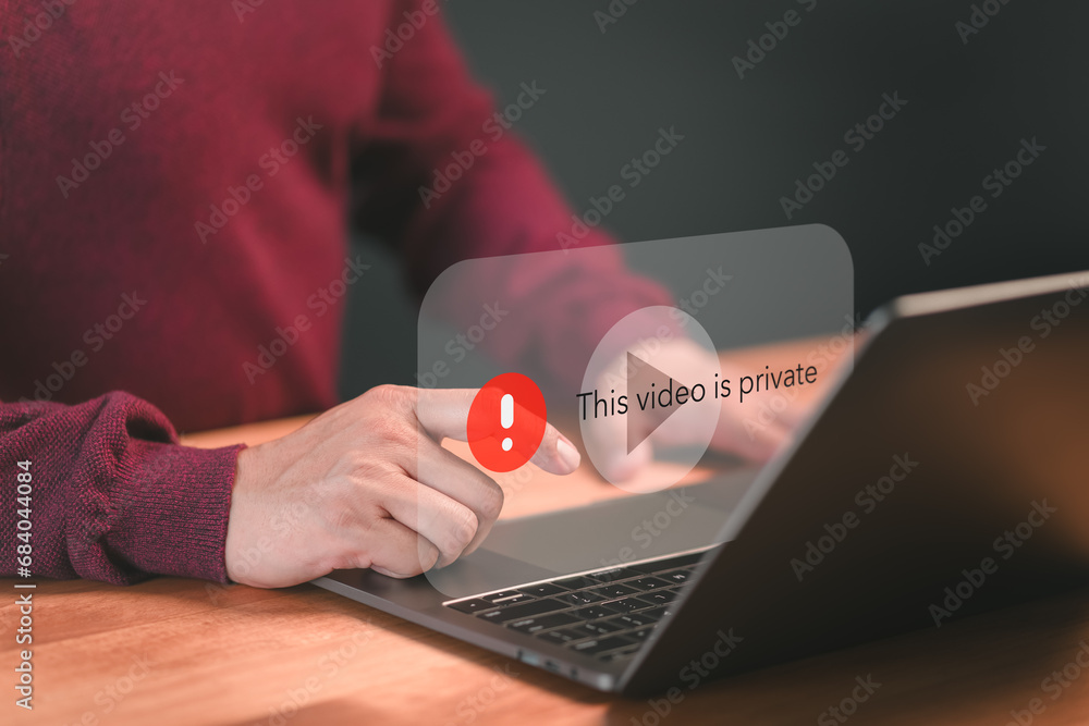 Poster Young man using a laptop to play social media but this video is blocked or privacy settings have been set. Searching for more internet, and search engine optimization. Subscribing and following.