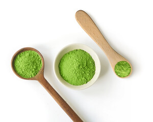 Green tea matcha powder in measuring spoons and cup or bowl