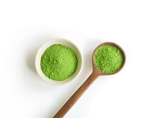 Green tea matcha powder in wooden spoon and cup or bowl