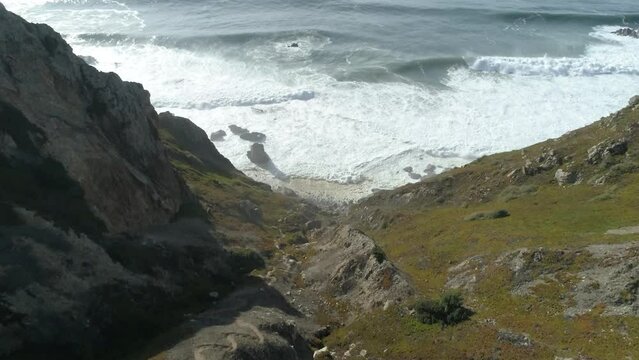 Drone footage of the remote Ursa Beach (Praia da Ursa) on a sunny day in Cabo da Roca, Portugal