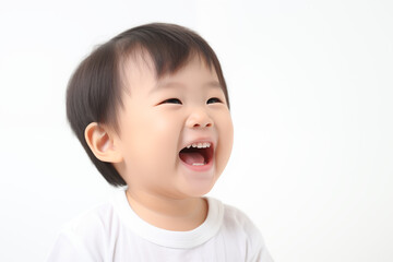 Close-Up Portrait of a Cheerful and Adorable Young Asian Boy Against a White Background, Radiating Vibrant Emotions and Infectious Baby Laughter