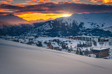 Ski resort with deep snow at sunrise, La Toussuire, France
