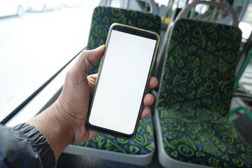 passenger sitting in a bus using his phone. - obrazy, fototapety, plakaty