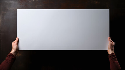 hands holding a blank sign up in the air upon dark background