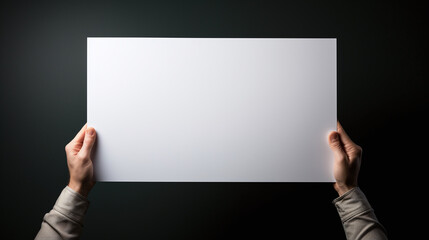 hands holding a blank sign up in the air upon dark background