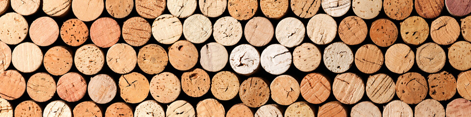 Long wide banner of wine cork from white wine, natural texture used bottle stoppers top view, beige...