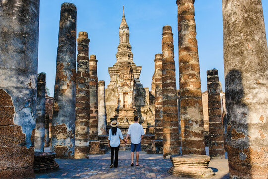 Asian women and Caucasian men visiting Wat Mahathat Sukhothai, an old city in Thailand. Ancient city and culture of South Asia Thailand, Sukhothai Historical Park