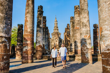 Sukothai historical park Thailand, A Couple of men and women visit Wat Mahathat, Sukhothai's old...