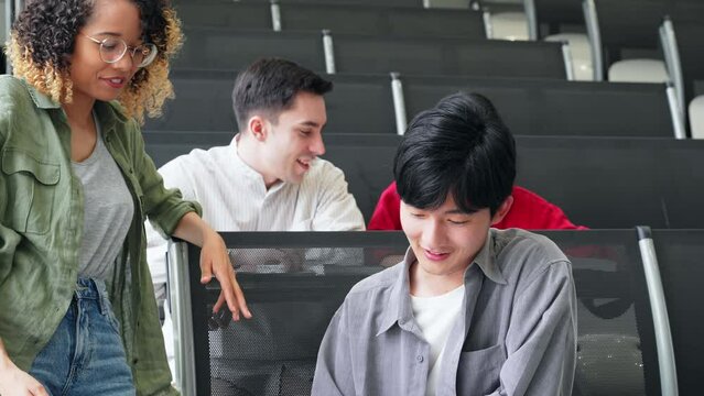 Group of multinational students having a conversation in a classroom.