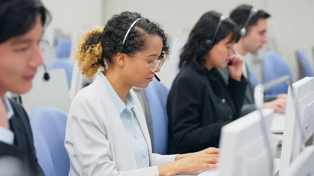 Multinational operator group working in the office. Computer class. System engineering.