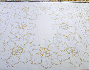 Making batik by drawing beautiful patterns by hand.
