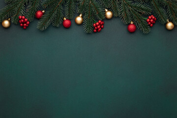 Christmas decoration on dark green background, empty space. Festive New Year mockup with tinsel. Vintage frame. Gold, red ornaments. Celebration card, bauble. Top view. Evergreen tree. Blank template.