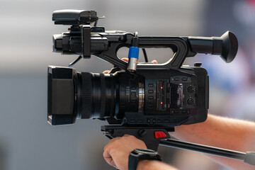 TV camera records a speaker on stage, delivering impactful insights and engaging the audience, on...