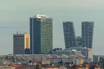 Prague, Czech Republic - October 23 2023: Evening view of the buildings from distance, a skyscraper, the hotel and the V Tower standing at Pankrac, a city district.