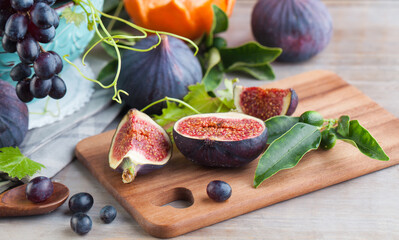 Fresh figs fruit on brown wooden table, healthy food close up