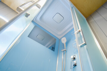 The clean and modern bathroom design includes a spacious shower cabin.
