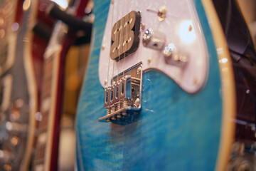 Electric guitar in a music shop, close-up. Blue guitar
