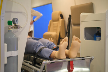 Patient lying on a stretcher in a training dummy in an ambulance. Medical equipment.