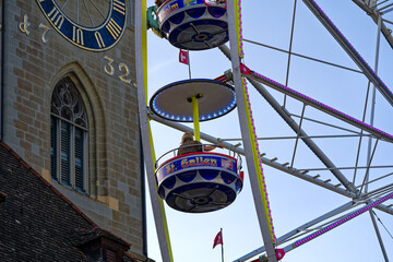Fun fair named Züri Fäscht at City of Zürich with close-up of gondolas of ferris wheel and Swiss...