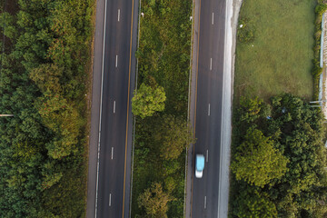 Aerial view rural transport asphalt road with vehicle in forest