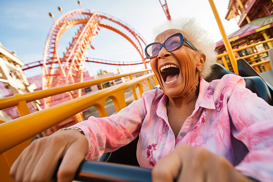 Happy Senior Woman With Gray Hair Riding A Rollercoaster At Amusement Park And Scream