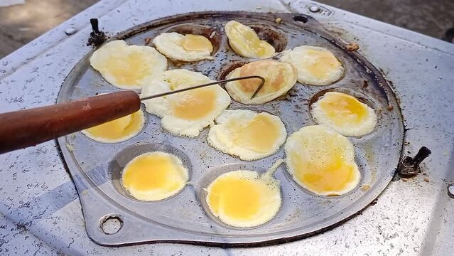 the process of cooking mini omelettes, street food from Indonesia.
