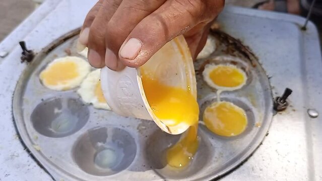 the process of cooking mini omelettes, street food from Indonesia.