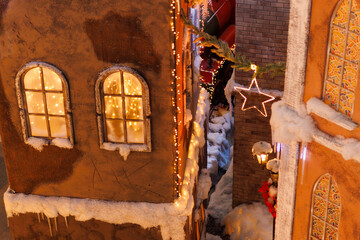 New Year's decorations, toys and garlands on the windows in fabulous scenery. Houses for children...