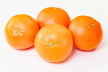 Tangerine or clementine with green leaf isolated on white background