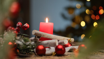 Christmas red candle under the tree