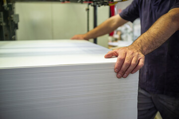 Loading paper onto an offset printing machine operation