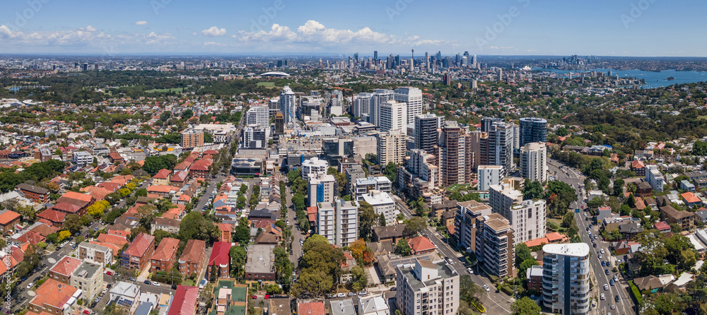 Wall mural Panoramic aerial drone view of Bondi Junction in the Eastern Suburbs of Sydney, NSW Australia with Sydney City in the background on a sunny day