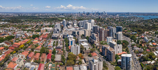 Panoramic aerial drone view of Bondi Junction in the Eastern Suburbs of Sydney, NSW Australia with Sydney City in the background on a sunny day - obrazy, fototapety, plakaty