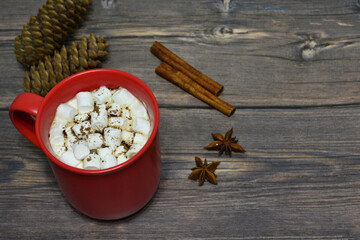 red mug with cocoa and marshmallows on wooden background 