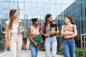 Cheerful multiracial student girls walking after university classes - Diversity in Higher Education