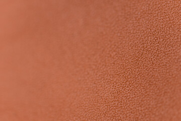 Closeup photo of bright orange full grain leather