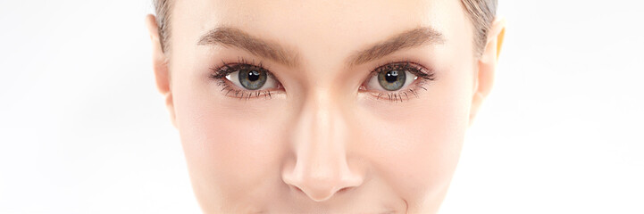 Obraz premium Close-up shot of beautiful woman's eyes on white background.