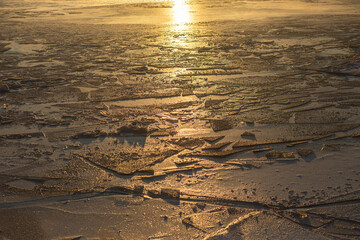 sunset in a White sea with ice floes 