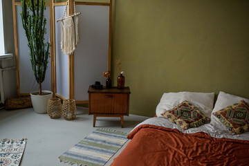 Bedroom in boho-chic style, simple and comfortable design with fashionable accessories for home