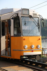 Old yellow tram stopped at terminal without people