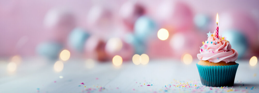 Tasty birthday cupcake sits on a table against a bright backdrop 
