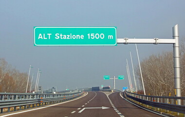 road sign in the motorway which means stop station at 1500 m because you have to pay the toll