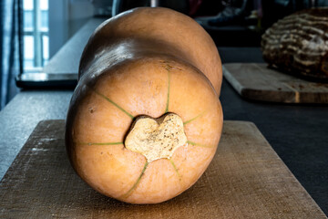 A whole Butternut squash on a cutting board.