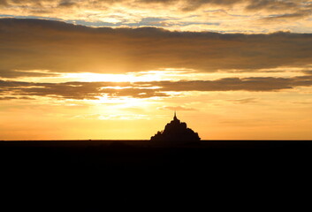 abbey of Mont saint-michel in Normandy in northern France at sunset with fiery sky