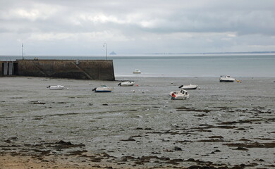 Cancale in Brittany in France famous for low tides and boats beached on the beach