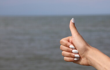 hand of young girl with thumbs up